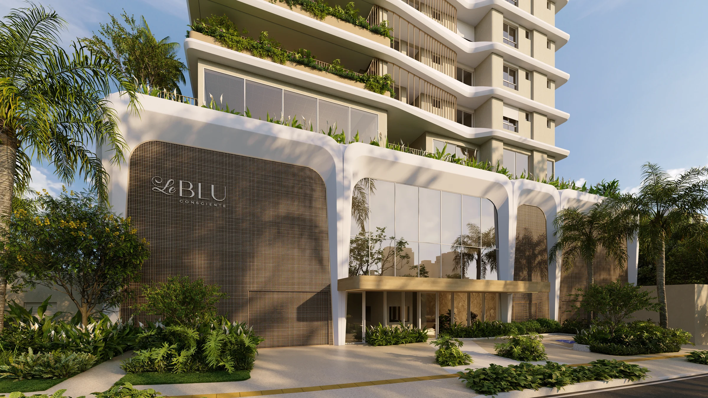 Entrada principal com porte-cochère, pé-direito duplo em vidro e letreiro do empreendimento Le Blu