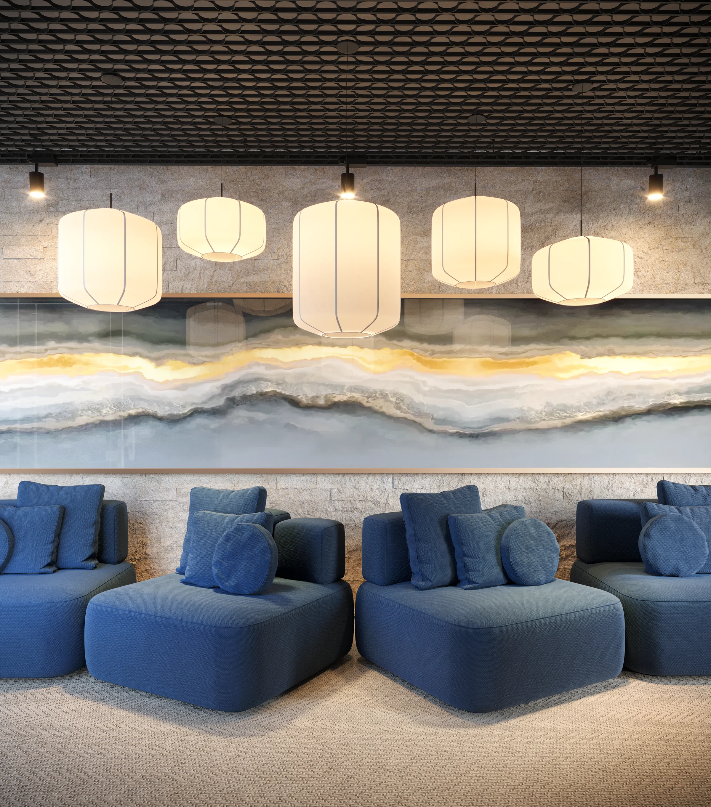Lobby de entrada com sofás modulares azuis, luminárias pendentes e parede em pedra rústica
