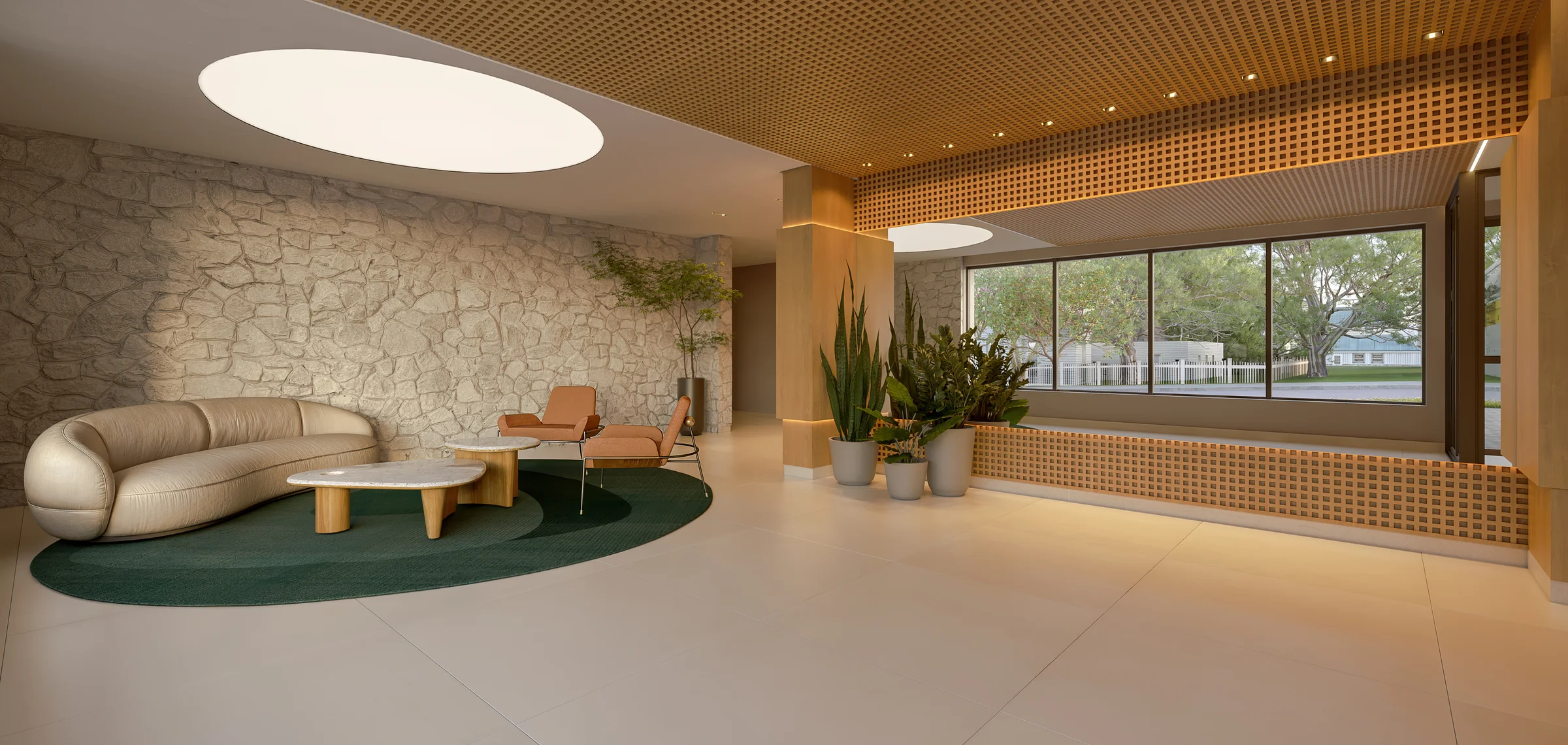 Lobby de entrada com parede em pedra natural, forro trabalhado e sofá curvo
